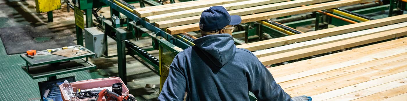 An employee working at South Coast Lumber